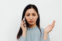 Kaboompics - Asian Woman Expressing Concern During a Smartphone Call