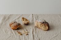 Kaboompics - Broken Bread on Linen With Copy Space