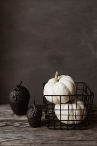 Dark Moody Halloween Decor With White Pumpkins and Black Candles