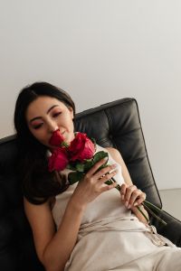 Kaboompics - Woman Smelling Roses in Romantic Home Interior