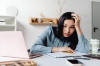 Kaboompics - Portrait of an Asian Woman Facing Workplace Burnout at an Office Desk