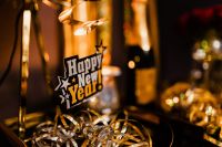 Kaboompics - Happy New Year Tag on Champagne Bottle with Gold Curled Serpentines