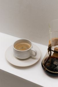 Kaboompics - White Coffee Cup and Chemex Brewer on White Table