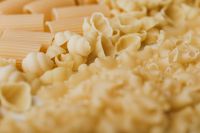 Kaboompics - Assorted Shell Pasta Shapes in a Warm Neutral Macro Food Styling Background