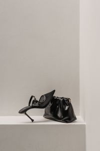 Kaboompics - Black Woven Heel and Ruched Handbag on Plinth