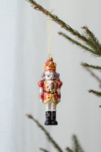 Kaboompics - Red Nutcracker Ornament on a Fir Branch