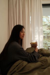 Kaboompics - Cozy Bedroom Morning with a Woman Holding a Drink