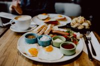 Kaboompics - Fried Eggs and Sausages with Toast and Condiment Bowls