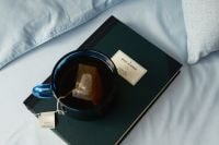 Kaboompics - Cup of Green Tea on Dark Green Journal