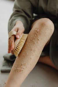 Kaboompics - Dry Brushing Sea Salt Body Scrub into Skin with a Natural Body Brush