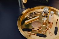 Kaboompics - Makeup essentials on a golden tray