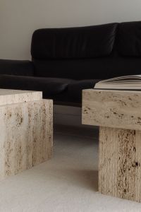 Kaboompics - Black De Sede Sofa with Travertine Tables in Warm Interior