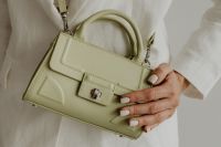 Kaboompics - Overhead View of Pale Sage Handbag and Hand on White Outfit