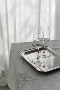 Kaboompics - Two Wine Glasses on Reflective Metallic Tray