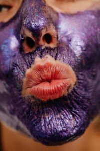 Kaboompics - Close-Up Portrait of Pursed Lips Beneath a Textured Purple Face Mask