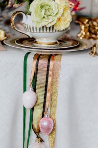 Kaboompics - Floral Teacup with Cream Roses above Hanging Easter Egg Decorations and Ribbons