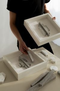 Kaboompics - Designer Arranging Textured Wall Art Sculptures in a Framed Panel