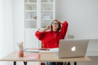 Kaboompics - Work from Home Lifestyle: Relaxed Woman Taking a Phone Call beside Laptop and Color Swatches