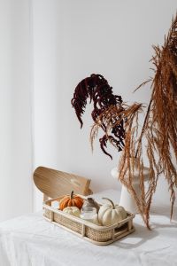 Kaboompics - Minimal Pumpkin Decor with Dried Flowers on a White Table