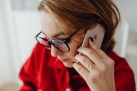 Kaboompics - Woman Wearing Eyeglasses and Talking on Phone in Home Office