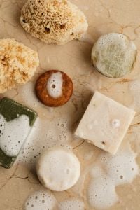 Kaboompics - Natural Sea Sponges and Soap Bars on a Foamy Stone Surface