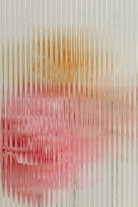 Kaboompics - Abstract Pink and Amber Flower Shapes Behind Ribbed Glass, Soft Botanical Background Texture