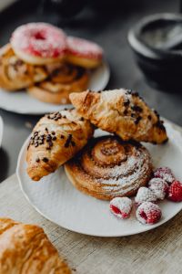 Kaboompics - Chocolate Chip Croissants and Iced Raspberry Buns on a Plate