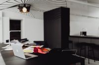 Kaboompics - Interior Designer's Studio with MacBook, Fabric Swatches, Material Boards and Black Worktable