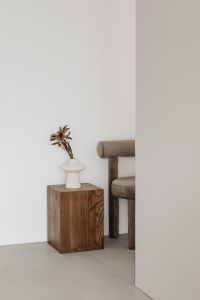 Kaboompics - Minimalist Interior with Walnut Pedestal, Sculptural Vase and Upholstered Chair
