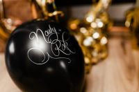Kaboompics - Black New Year Balloon with Blurred Gold Party Decorations