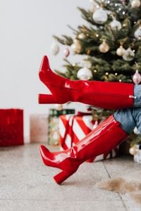 Kaboompics - Crossed Red Boots in Front of a Christmas Tree