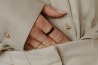 Kaboompics - Woman's Hand with Rings Against Tan Silk Shirt