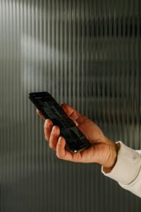 Kaboompics - Smartphone Showing Social Media in Front of Glass Doors