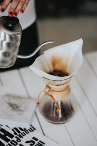 Kaboompics - Woman pouring water in Chemex filter coffee maker