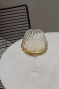 Kaboompics - White Wine at Bistro Table With Wire Chair