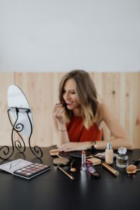 Kaboompics - Vertical Beauty Makeup Photo with Copy Space, Woman Applying Lipstick at Mirror