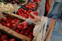 Kaboompics - Woman Holding a Tomato at a Farmers Market