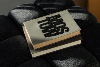 Kaboompics - Editorial Reading Aesthetic with Hardcover Book on Black Lounge Chair