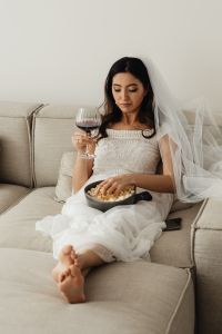 Kaboompics - Barefoot Bride Eating Popcorn in a Wedding Dress on the Couch