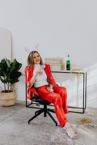 Kaboompics - Relaxed Woman in Red Suit Sitting in a Black Swivel Chair