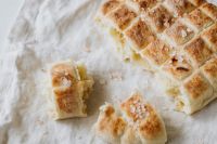Kaboompics - Scored Slovenian Loaf on Crumpled Linen, Rustic Food Styling with Copy Space