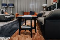 Kaboompics - Small Black Side Table with Books in Contemporary Living Room