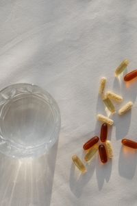 Kaboompics - Capsules and Water Glass in Sunlit Healthcare Still Life