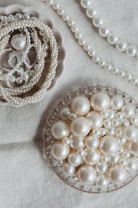 Kaboompics - Two-Bowl Pearl Jewelry Flat Lay with Layered Necklaces, Scalloped Dish and Crystal Bead Bowl