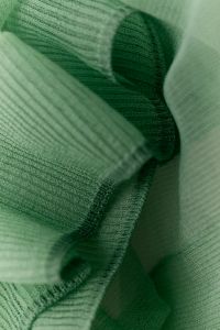 Kaboompics - Green knit fabric layers with ribbed trim close-up