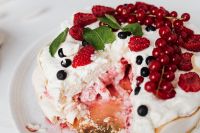 Kaboompics - Pavlova Cake with a Slice Removed, Fresh Berries and Crumbled Meringue