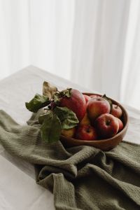Kaboompics - Red and Golden Apples in a Rustic Wooden Bowl on Olive Linen, Autumn Fruit Still Life