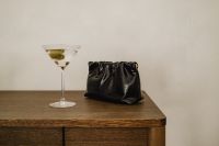 Kaboompics - Martini Cocktail and Black Clutch on a Wood Table