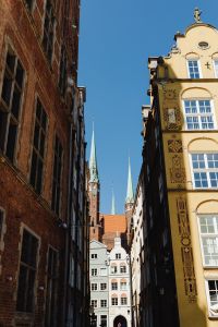 Kaboompics - Gdańsk Old Town Gothic Church Spires Rising Between Brick and Ornate Townhouse Facades