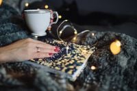 Kaboompics - Cozy Hygge Book and Cup with Golden Fairy Light Bokeh